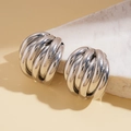 Detail of silver layered textured geometric earrings on stone display with sharp shadows - Iron/925 Silver Pin / Silver