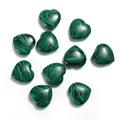 Top view of ten heart-shaped malachite gemstones with natural green stripe patterns - Malachite