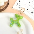 Balloon dog keychain in vibrant emerald green with a colorful laser iridescent finish - Iridescent Green