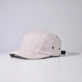 Detail of five-panel camper hat with metal eyelets and adjustable strap buckle - Beige