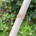 Detail eines 18K vergoldeten Blattrings mit Zirkonia auf einem weißen Displayständer - Blattform Offener Ring