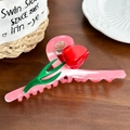 Pink tulip hair claw clip made of resin with red flowers and green leaves on wood - Pink