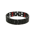 Macro detail of magnetic therapy bracelet showing inner magnets and dragon scale texture - Black