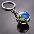 Macro shot of silver metal keychain with Van Gogh Starry Night glass dome pendant - Starry Night Over the Rhone