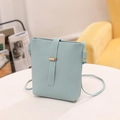 Elegant minimalist light blue bucket crossbody bag with sleek gold metal buckle detail - Lake Blue