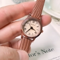 DOUKOU women's brown leather watch with rose gold case on a vintage book background - Brown