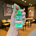 Close-up of green acrylic Lilith liquid quicksand keychain with dolphin charm and bell - Lobster Clasp Style / Noctilucent Bubble Bead Green