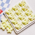 Detailed view of iridescent yellow resin bow beads for DIY jewelry and phone chains - 24*18mm / Light Yellow