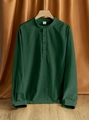 Detail of a dark green linen Henley shirt on a wood hanger with natural fabric texture - Army Green