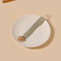 Detailed view of light green cotton crepe pacifier clip on a white ceramic plate - Light Green Style (4)