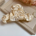 Detail of cream satin hair claw clip with elegant silk texture on a decorative tray - Cream Satin Pleated Style