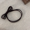 Dark brown elastic hair tie with minimalist bow decoration on beige woven background - Dark Coffee