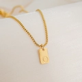 Macro detail of 18K gold plated box chain and rectangular pendant with letter O - Letter O
