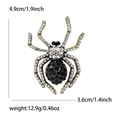 Golden alloy spider brooch with sparkling rhinestones, 4.9cm height by 3.6cm width - White