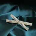 Golden bow hair clip with three rows of pearls on an elegant dark green silk background - A-Rice Bead Bow Spring Clip