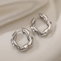 Minimalist silver irregular geometric earrings in twisted metal style on white silk background - Silver