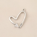 Detailed view of silver heart pendant with sparkling triangular zircon stone on fabric - PJ0291-Silver Hollow Heart Triangle Zircon