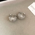 Macro view of silver hollow flower drop earrings on a grey velvet jewelry display tray - Hoop Earrings-Silver