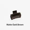 Detail view of a 4cm mini dark brown matte hair claw clip with a hollow square design - Matte Dark Brown