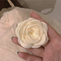 Elegant cream white fabric camellia flower hair clip held by hand for a sweet bridal look - Camellia Large Size