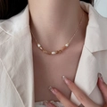 Tiger eye beaded necklace with white pearls and amber stones on a cream blazer - Strawberry Crystal Necklace XL0174