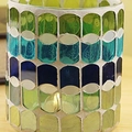 Colorful glass mosaic candle holder in green, blue, and yellow with warm interior light - Blue Green Wave