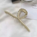 Elegant gold twisted metal hair claw clip with a glossy finish on white silk background - Screw Back
