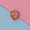 Close-up of 13mm heart-shaped stainless steel pendant with orange glitter resin inlay - Orange Iridescent Style(10)