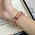 Detail of pink natural strawberry quartz double-layer beaded bracelet on a woman wrist - Sunstone & Red Agate Double Layer Bracelet