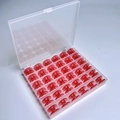 36 Red Bobbins In A 36-compartment Box / Shuttle Core Storage Box