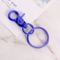 Purple painted metal lobster clasp with key rings on a marble background - Dark Blue