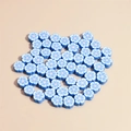 Macro view of light blue polymer clay flower beads for DIY jewelry making and bracelets - Dark Blue