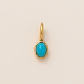 Detail view of oval blue gemstone pendant with 18K gold plated stainless steel bezel - December Oval Birthstone Pendant Only (Without Chain)