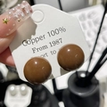 Close-up of smooth brown spherical earrings made of 100% copper with a glossy finish - 9# Silver Needle-Coffee-Oblate