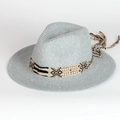 Detailed close-up of woven fedora hat with blue straw texture and bohemian tassel band - Adjustable / Blue