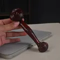 Deep red sandalwood Ruyi pendant with cloud relief carving in a hand-held view - Red Sandalwood Large Ru Yi