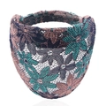 Macro shot of dark blue lace headband with green floral pattern and elastic band - Green