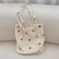 Dettaglio della borsa tote in velluto a coste beige con orsetti e trama del tessuto - Bianco Sporco
