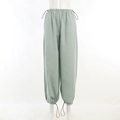 Detail of light green cargo pants showing the drawstring waist and lightweight fabric - S / Light Green