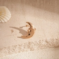 Detail of gold crescent moon face ear cuff on beige stone with coastal shell decor - Clip Earring - Gold Moon Face