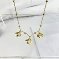 Detail of gold-plated necklace featuring three tropical fish pendants on beaded chain - Fish