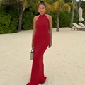Close-up of red knitted halter neck maxi dress with backless design and ruffle details - S / Red