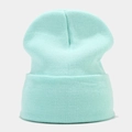 Detail shot of the fine knit texture and folded cuff on this mint green winter beanie - Aqua