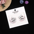 Close-up of iridescent acrylic face rhinestones in white paper packaging for makeup - Pink AB