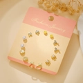 Golden titanium steel earring set with heart, flower and pearl designs on pink card - Gold Pearl Heart Flower (E1922-1)