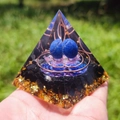 Handmade orgone energy pyramid with blue spheres and copper coils on green lawn - F-3-3 Blue Energy Sphere
