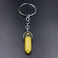 Detail view of yellow hexagonal crystal pendant attached to a silver keychain ring - Topaz