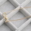 Detail view of gold infinity necklace featuring Love script and colorful zircons on display - Infinity Love Necklace
