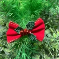 Red velvet Christmas bow with green holly leaves and gold stitching on pine branches - Velvet Ribbon Christmas Style 5