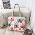 Ethnic style floral canvas tote bag with colorful butterflies and flowers on a sofa - Style 1